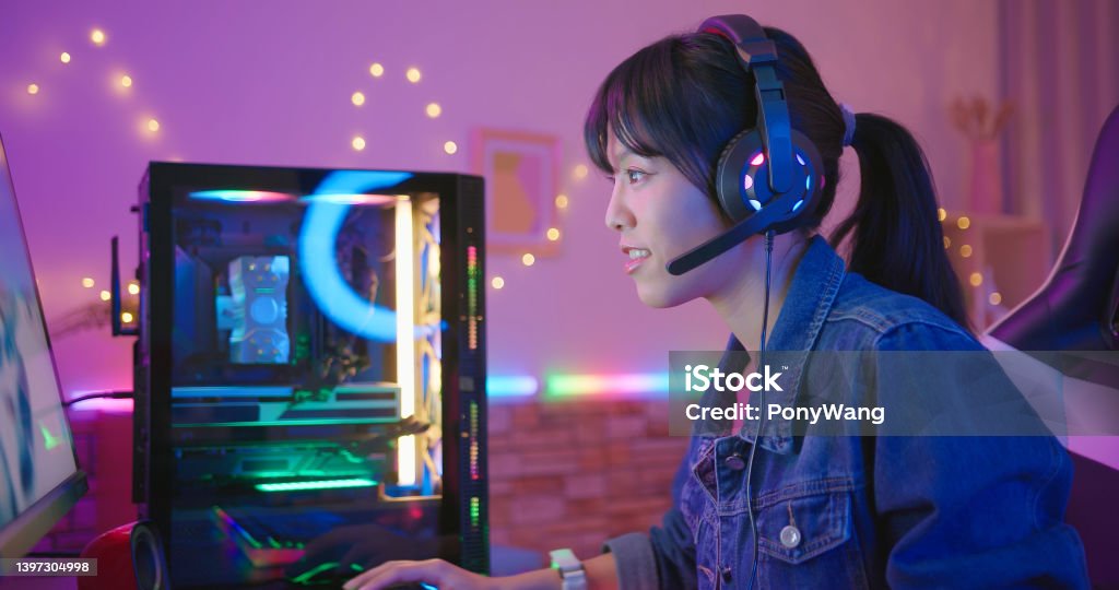 cyber sport gamer play game young asian pretty pro gamer wearing headset is chatting with player while playing in online video game at home Gamer Stock Photo