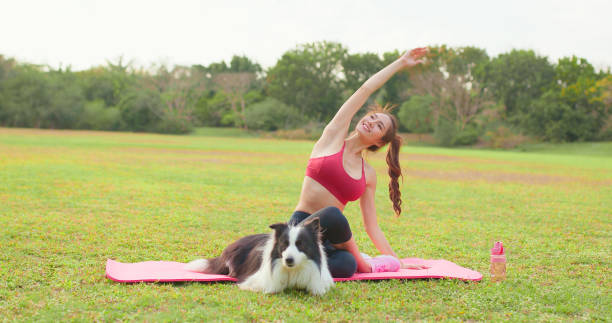 istock girl practice yoga with dog 1397305111