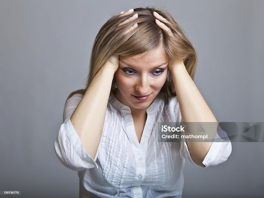 Woman in depression on gray background Adult Stock Photo