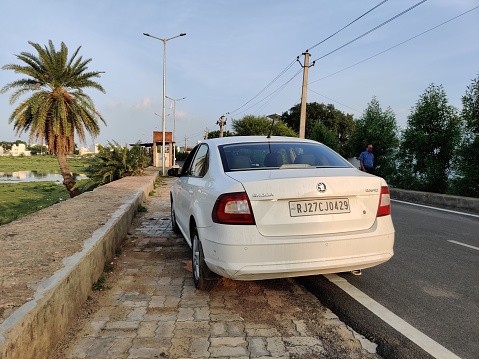 Udaipur, India - July 26 2020: White Skoda Rapid - Back View - 2019 Indian Model