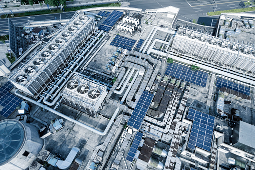 Aerial picture of building rooftop with air conditioning equipment and solar panels