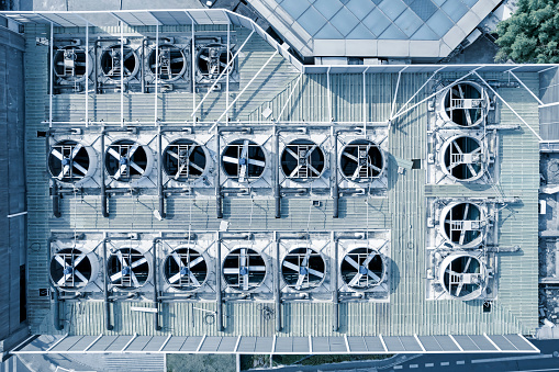 Aerial picture of building rooftop with air conditioning and ventilation equipment