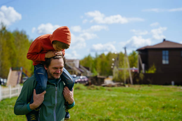 istock dad rides his son on his back 1397311553