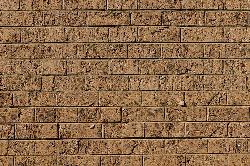 Close-up on an old brown brick wall.