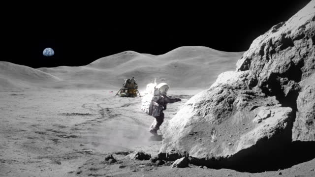 Astronaut exploring the moon. Distant planet Earth in the sky