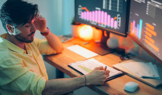 istock Businessman at home working late 1397317288