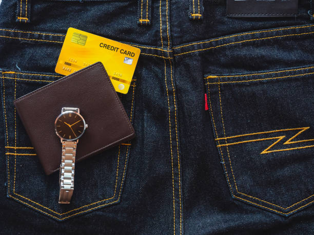 istock Brown leather wallet on jeans background. 1397323371