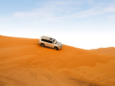 Dubai, United Arab Emirates - 24 November 2021: Desert safari with Dune bashing by a 4x4 car is a very popular activity.