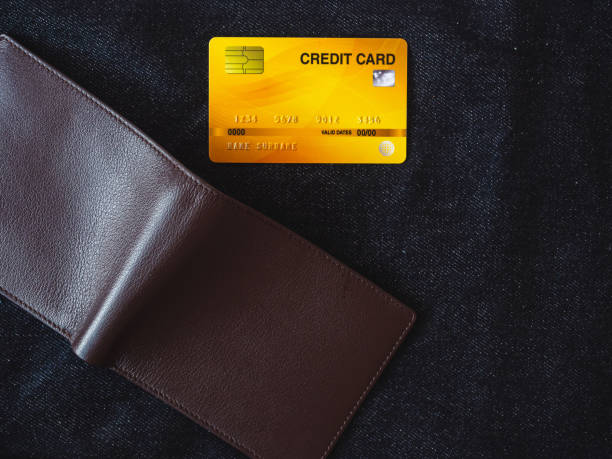 istock Brown leather wallet on jeans background. 1397324137