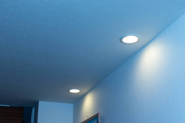 Aisle illuminated pale by a downlight on the ceiling