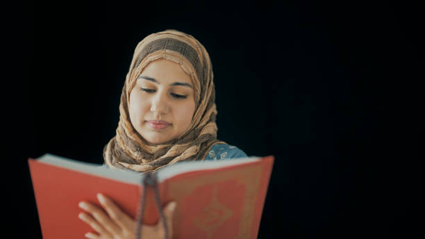istock islamic woman sitting happily reading religious books 1397326031
