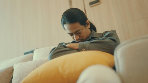 Male employee sleeps at work because of fatigue from work.