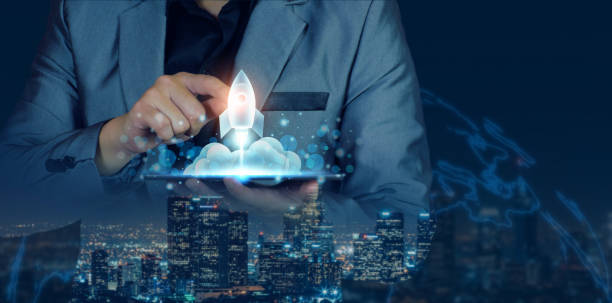 istock Startup business concept. Businessman holding a tablet, rocket launching and soar flying out from screen, starting a business, growing business, modern technology, hologram, network connection. 1397328101