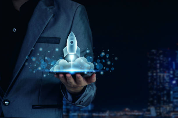 istock Startup business concept. Businessman holding a tablet, rocket launching and soar flying out from screen, starting a business, growing business, modern technology, hologram, network connection. 1397328106