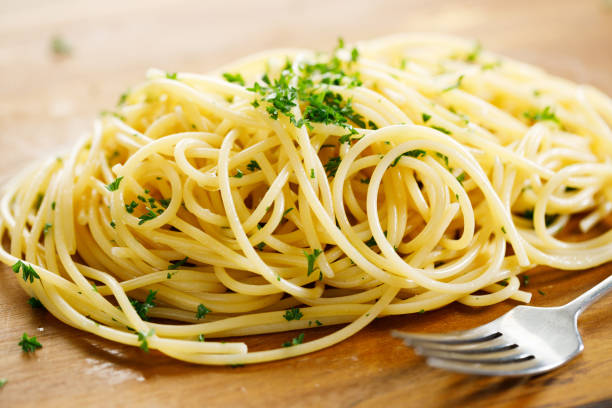 istock cooked spaghetti pasta on wooden plate. 1397328332