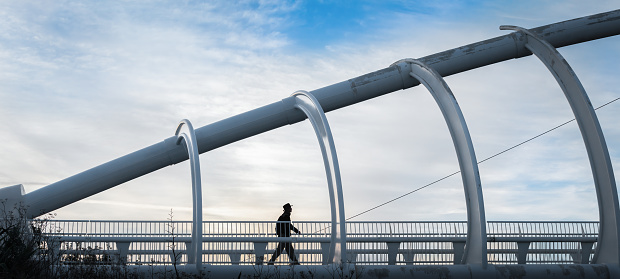 Silhouette man walking on Te Rewa Rewa bridge, Bridge under maintenance, New Plymouth