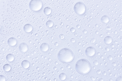 Water drops on white background. Abstract drops of gel. Face serum cosmetics.
