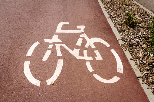 White bicycle symbol on a road in a bicycle lane.