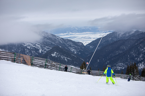 Slovakia, Jasna - February 4, 2022: people skiers eating on the top of the slope. copy space