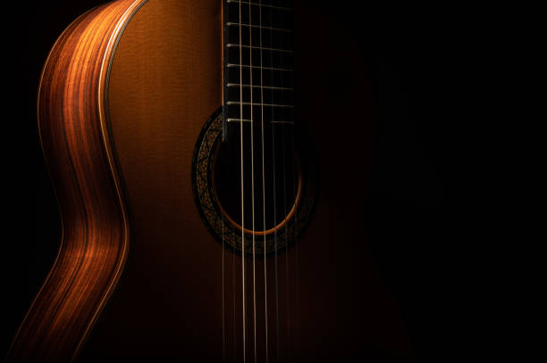 Classical guitar Classical guitar on a black background with copy space acoustic guitar photos stock pictures, royalty-free photos & images
