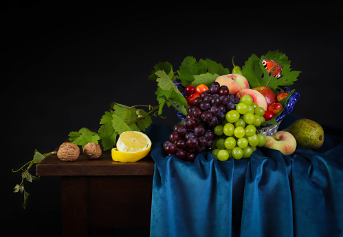 Still life with cheese and grapes on a table