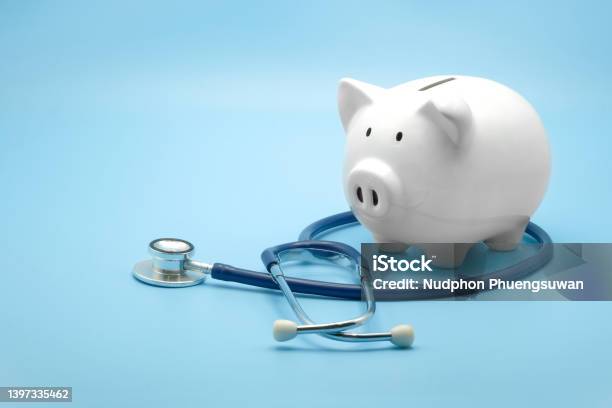 Piggy Bank With Stethoscope Isolated On Light Blue Background With Copy Space Health Care Financial Checkup Or Saving For Medical Insurance Costs Concept Stock Photo - Download Image Now