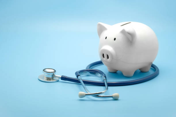 piggy bank with stethoscope isolated on light blue background with copy space. health care financial checkup or saving for medical insurance costs concept. - currency stethoscope medicare usa imagens e fotografias de stock