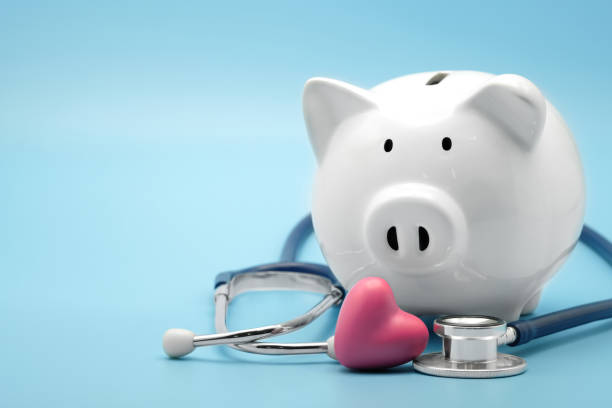 Piggy bank with stethoscope and heart isolated on light blue background with copy space. Health care financial checkup or saving for medical insurance costs concept. Piggy bank with stethoscope and heart isolated on light blue background with copy space. Health care financial checkup or saving for medical insurance costs concept. medicare stock pictures, royalty-free photos & images