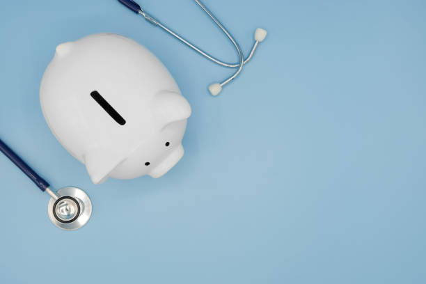 top view of piggy bank with stethoscope isolated on light blue background with copy space. health care financial checkup or saving for medical insurance costs concept. - currency stethoscope medicare usa imagens e fotografias de stock
