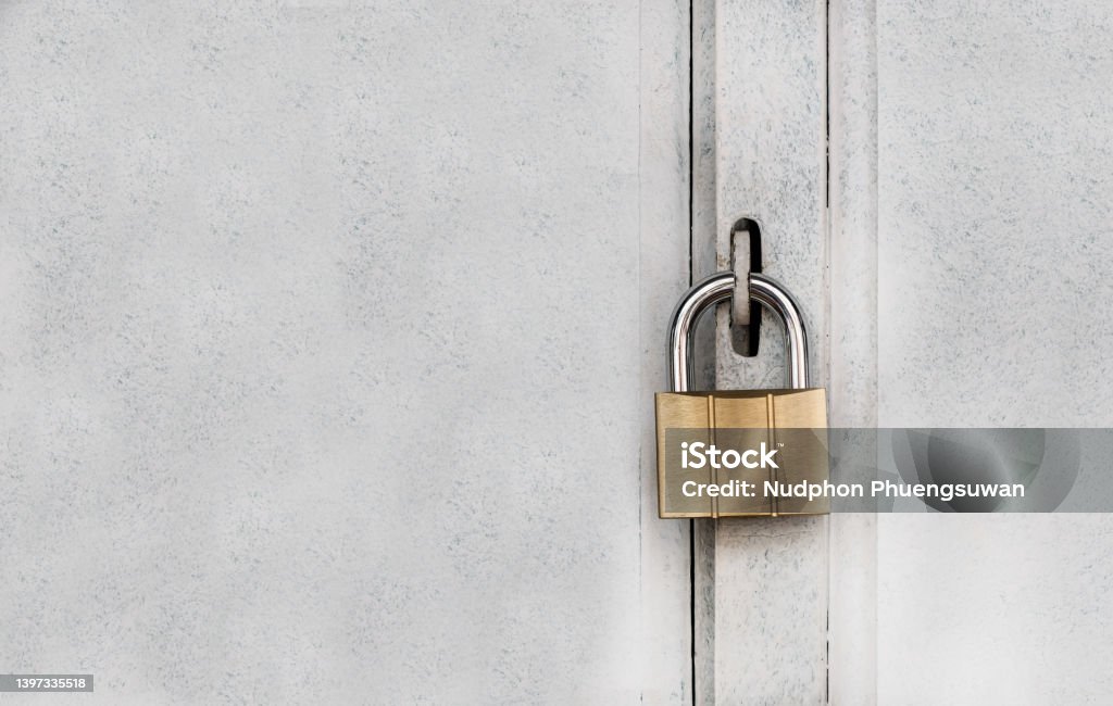 Metal padlock on door steel with copy space. Concept of safe lock and protection concept. Padlock Stock Photo