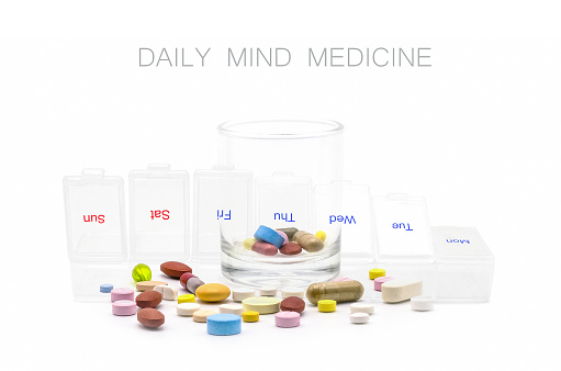 Double exposure of various pills with medicine box and drug bottle on white background. Daily vitamins and supplements dosage routine concept. With copy space and blank for text.
