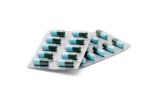 Close up on tablets and capsules pill in blister packaging, Pharmaceutical industry concept. Pharmacy drugstore, Amoxicillin capsule pills isolated on white background with clipping path.