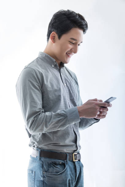 Using smart phone for business, energetic and handsome Chinese Japanese and Korean young man - stock photo stock photo