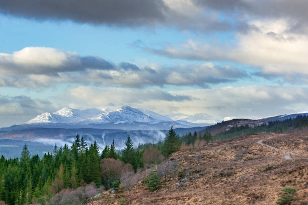 Great Glen Way One of the most scenic sections of the Great Glen Way overlooks the village of Fort Augustus and the snow capped mountains beyond fort augustus stock pictures, royalty-free photos & images