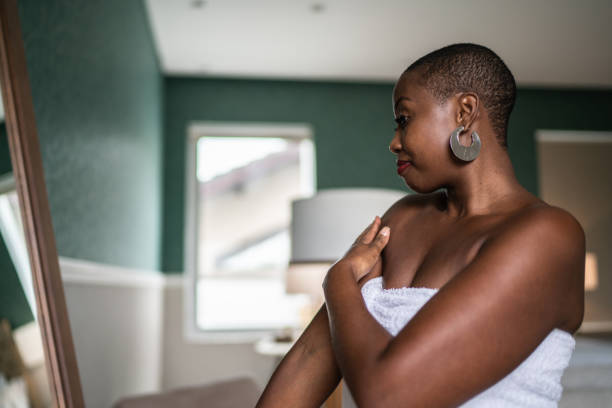 istock Woman wearing a towel applying moisturizer 1397341001