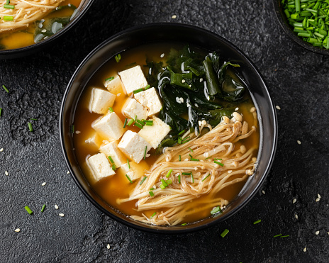 Rich miso soup with enoki mushrooms, wakame seaweed and tofu, vegetarian, vegan Asian food