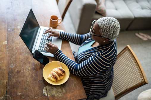 Mature woman working on the laptop at home