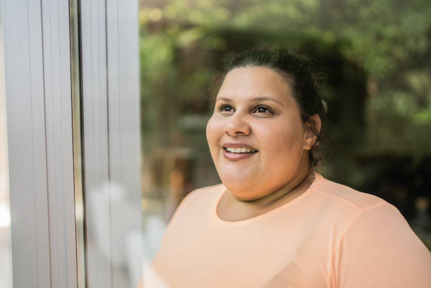 istock Contemplative mid adult woman looking through window 1397342441