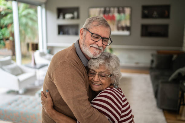 istock Senior couple hugging each other at home 1397342786