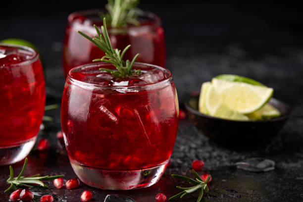 istock Pomegranate gin cocktail with lime, rosemary and ice on rustic black table 1397342790