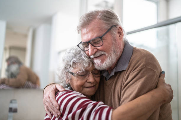 istock Senior couple hugging each other at home 1397342819
