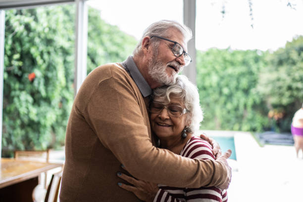 istock Senior couple hugging each other at home 1397342852