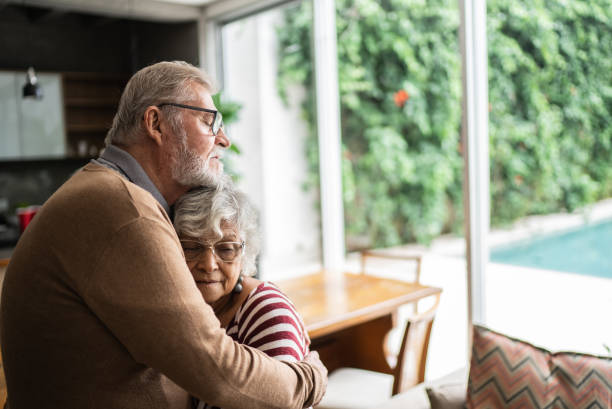 Senior couple hugging each other at home