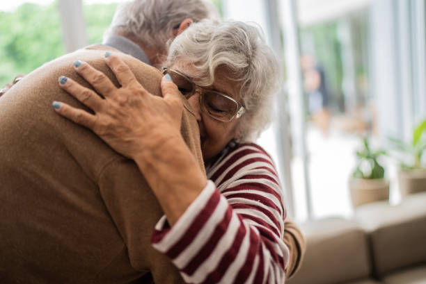 istock Senior couple hugging each other at home 1397342869