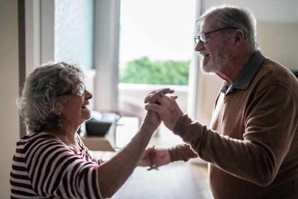 istock Senior couple dancing at home 1397342882