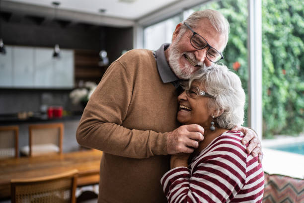 istock Senior couple hugging each other at home 1397342889
