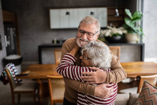 istock Senior couple hugging each other at home 1397342893