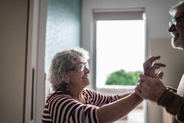 istock Senior couple dancing at home 1397342896