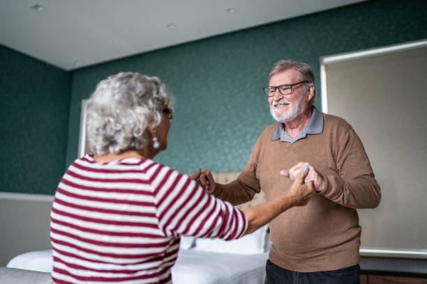 istock Senior couple dancing at home 1397342902