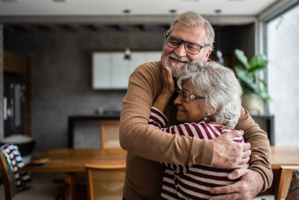 istock Senior couple hugging each other at home 1397342913